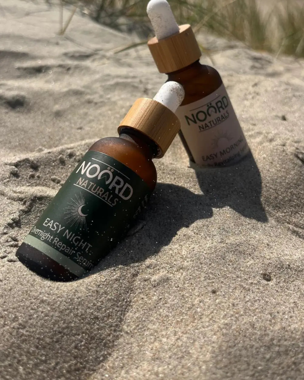 Noord Easy Night and Easy Morning serums in the sand